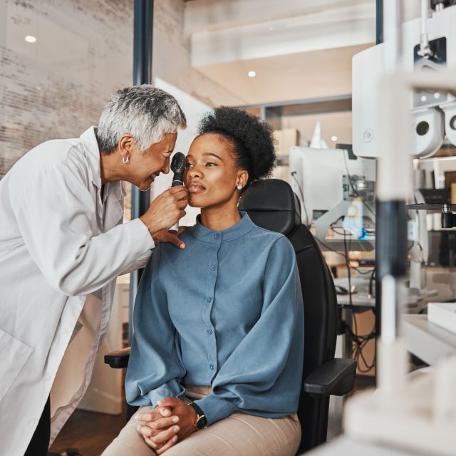Eye doctor examining patient's retina with specialized equipment